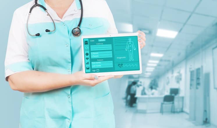 Doctor holding a tablet with a healthcare app on screen
