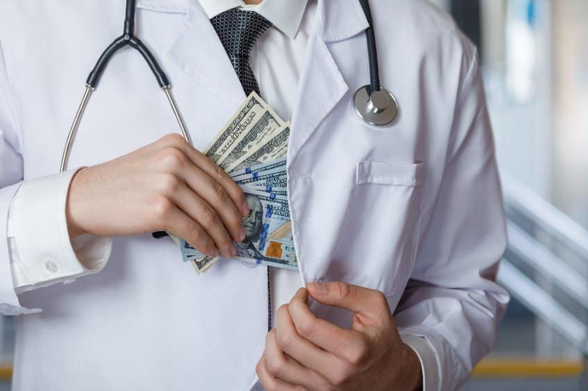 doctor holding cash
